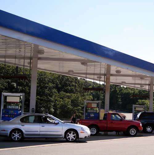 Image of a gas station with customers paying optimized retail fuel prices