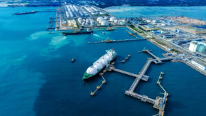 LNG (Liquified Natural Gas) tanker anchored in Gas terminal gas tanks for storage. Oil Crude Gas Tanker Ship. LPG at Tanker Bay Petroleum Chemical or Methane freighter export import transportation and logistics